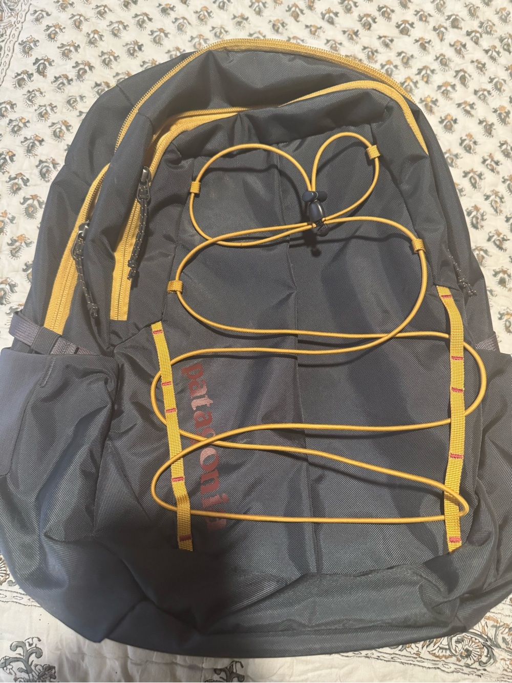 Patagonia Black Backpack with Yellow Trim and Bungee Cord